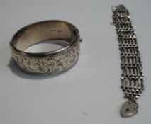 A silver hinged bangle; and a silver gate link bracelet;