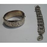A silver hinged bangle; and a silver gate link bracelet;