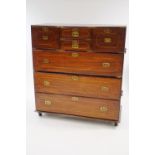 A Campaign style two section mahogany chest, the top half with an arrangement of five drawers,