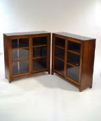 A pair of Indian hardwood display cabinets with sliding glazed doors,