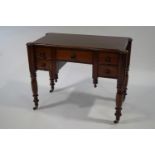 A Victorian mahogany side table, with five drawers, upon turned legs,