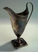 A George III helmet shaped pedestal cream jug, by William Brind, London 1788,