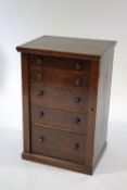 A 19th Century oak Wellington chest with five drawers, turned handles and a plinth base,