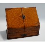 An early 20th Century oak stationery cabinet, of sloped form,