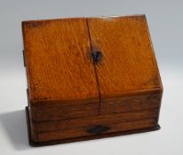 An early 20th Century oak stationery cabinet, of sloped form,