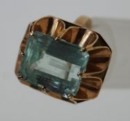 A single stone aquamarine ring, the native cut rectangular stone, measuring approximately 14.