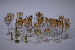 A 20th Century suite of Austrian glasses, each decorated in gilt, four in six shapes,