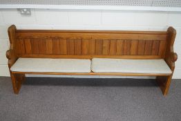 A 20th Century pine Church pew, with cushions,
