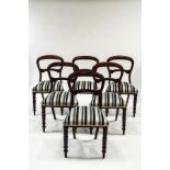 A set of six Victorian mahogany dining chairs with stuffed over seats and turned legs