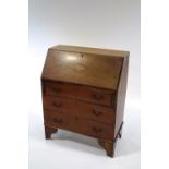 An Edwardian mahogany bureau, the fall front with shell paterae,