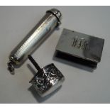 A silver cigar holder case; a silver match box cover; and a filled silver cane top;