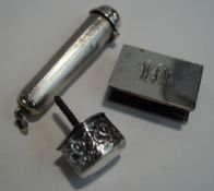 A silver cigar holder case; a silver match box cover; and a filled silver cane top;