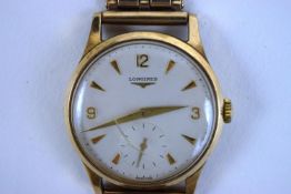 A Longines 9 carat gold gentleman's wristwatch, the circular off-white dial with gilt dagger batons,