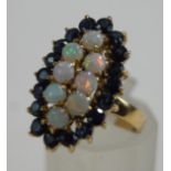 An opal and sapphire cluster ring, stamped '585',