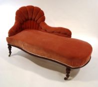 A Victorian mahogany chaise longue, with red button back upholstery,