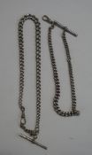 A silver watch chain, of graduated solid curb links, with a swivel and a T bar,