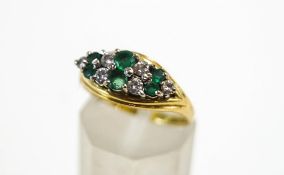An 18 carat gold, emerald and diamond dress ring,