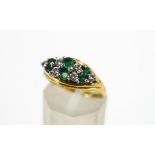 An 18 carat gold, emerald and diamond dress ring,