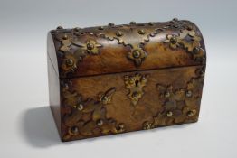 A 19th century walnut domed casket, with brass studded mounts, ivory label for Parkins & Gotto,