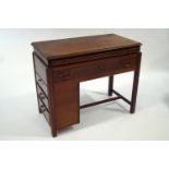 An unusual mahogany desk, with slide out writing surface over two long drawers,