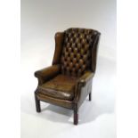 A 20th Century leather Chesterfield style armchair, with metal studding,