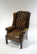 A 20th Century leather Chesterfield style armchair, with metal studding,