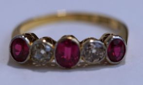 A five stone ruby and diamond ring, stamped '18ct' and 'Plat',