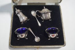 A cased silver four piece cruet set, with liners to the two salts, a mustard pot, and a pepper,