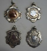 A collection of four silver hallmarked inscribed watch fob medallions,