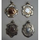 A collection of four silver hallmarked inscribed watch fob medallions,