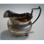 A George III silver cream jug, makers mark rubbed, London 1809, of rounded rectangular shape,