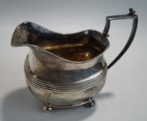 A George III silver cream jug, makers mark rubbed, London 1809, of rounded rectangular shape,