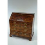 A George III and later walnut and feather banded bureau,