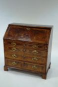 A George III and later walnut and feather banded bureau,