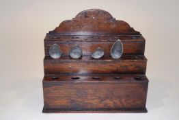 An 18th Century oak three tier spoon rack, each tier with five holes, 33cm high x 37cm wide,