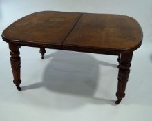 A Victorian mahogany oval ended wind-out dining table, with two additional leaves,