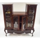 An Edwardian mahogany display cabinet with scroll glazing bars and the middle with bow fronted