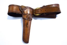 A tooled leather gun holster, with maker's stamp D.J.