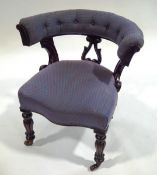 A Victorian mahogany club chair, with patterned blue button back upholstery,