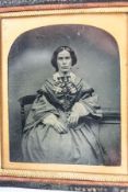 A Victorian Ambrotype of a seated lady, within a leather case, overall 8.5cm x 9.