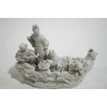 A Chinese blanc de chine figure group of four ladies in a boat,