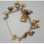A 9 carat gold bracelet, of filed curb links, with charms attached, 13.