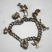 A silver bracelet, of double curb links, with charms attached,