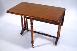 A Victorian mahogany Sutherland table with turned legs and brass casters,