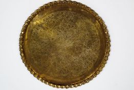 A large brass Indian table top,