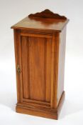 An Edwardian mahogany pot cupboard, with reeded panelled door,