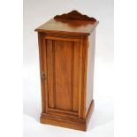 An Edwardian mahogany pot cupboard, with reeded panelled door,