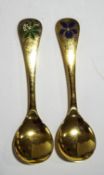 Two Georg Jensen silver gilt and enamel Christmas spoons, 'Woodruff' 1975, and 'Sweet Violet', 1977,