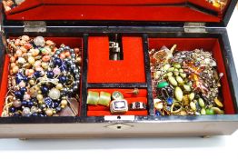 A jewellery box with costume jewellery, including dress rings, cufflinks, beaded necklaces,