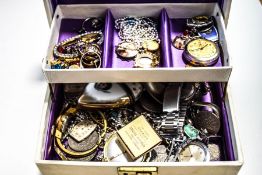 An assortment of costume jewellery and other items within a jewellery box,